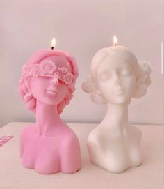 two candles that are sitting next to each other