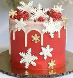 a red frosted cake with white snowflakes on it