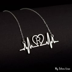 "Heart Beat Necklace, Silver Heart Rhythm Jewelry, EKG Necklace is made by hand in our workshop with care. All our jewelry is the most elegant choice for the Bridesmaids, friends, your loved ones and for yourself. Heart Beat Necklace, Silver Heart Rhythm Jewelry, EKG Necklace * Material: High Quality Solid 925 Sterling Silver. * Finish: Sterling Silver ∙ Gold ∙ Rose Gold. * All our jewelry is custom made by hand with care in our workshop.  HOW TO ORDER ❓ * Select your necklace COLOR. * Choose ne Customized Heart-shaped Sterling Silver Jewelry, Customized White Heart-shaped Necklace, Minimalist Heart-shaped Jewelry With Name, Gift Jewelry With Heart Beads In Stainless Steel, Customized Silver Heart Necklace For Gift, Minimalist Heart Shaped Personalized Jewelry, Customized Sterling Silver Heart Necklace For Valentine's Day, Customized Sterling Silver Heart Necklace, Customized Silver Heart Necklace For Anniversary