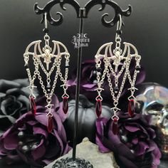 These Bat Chandelier Earrings have the perfect vampire vibes and showcase a victorian, gothic style. Enhance your nocturnal look and pair with our Chokers, Necklaces, Rings, and Bracelets.Bat Chandelier Earrings Details: Fashion Jewelry ~ Handmade Total Length: 92mm Width: 32mm Made with Red & Black Glass Crystal Beads Gothic Prom Jewelry, Gothic Resin Jewelry, Vampire Wardrobe, Bat Chandelier, Vampire Accessories, Goth Mom, Vampire Vibes, Vampire Earrings, Vampire Jewelry