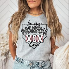 In My Baseball Mom Era Shirt, Baseball Mom Shirt, Game Day Shirt, Baseball Mama Shirt, Sports Mom Gifts, Mom Era Shirt, Gift for baseball How to order: -Select shirt size -Select shirt color -IMPORTANT Please select design color in the Personalization box. -Add to the cart and check out. Order is ready to ship i 1-3 business days. USPS First Class Mail (2-6 days) Need your order sooner. Upgrade to USPS Priority Mail (1-4 days) in cart for additional charge This tee is a favorite Bella Canvas cre Casual Baseball Jersey With Name Print, Athletic Heather Tops With Letter Print For Sports Events, Sports Tops With Letter Print For Baseball Season, Gray Letter Print T-shirt For Baseball Season, Mother's Day Sports T-shirt With Letter Print, Sporty Letter Print Tops For Mother's Day, Baseball Mom Shirts Ideas, Baseball Mom Tshirts, Sports Mom Gifts