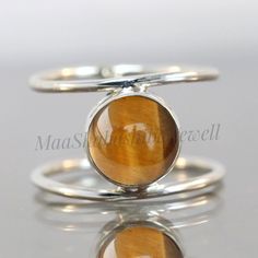 "Tigers Eye Ring, 925 Sterling Silver Ring, Gemstone Ring, Natural Stone, Handmade Gift for Her, Stacking Women Ring, Birthstone Jewelry SHOP LINK:- https://www.etsy.com/shop/MaaShabashibaJewell?ref=seller-platform-mcnav 》D E T A I L S《 Gemstone: Natural Tiger's Eye Gem Color: Brown Stone Shape: Round Metal: 925 Sterling Silver Purity: 925 Parts Per 1000 Setting Type: Bezel Set Silver Polish: High Ring Size: All Size Available Please note that there Can be slight variations in stone texture and Sterling Silver Gemstone Jewelry With Round Band, Sterling Silver Jewelry With Gemstone In Round Band, Sterling Silver Round Band Gemstone Jewelry, Silver Stackable Rings With Natural Stones, Sterling Silver Stackable Rings With Natural Stones, Spiritual Sterling Silver Round Birthstone Ring, Silver Jewelry With Ethical Gemstones In Open Band, Handmade Sterling Silver Birthstone Ring, Sterling Silver Gemstones With Natural Stones For Anniversary