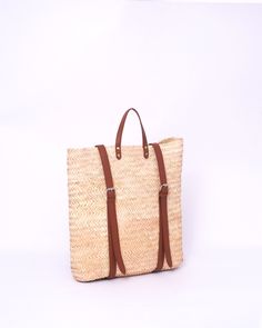 Do you want to look stylish and hippy? Get your hands on this handmade straw bag. It's high quality, eco-friendly, and handcrafted by women in Morocco. Its design is unique and timeless. Get yours now! we are proud to introduce our signature straw french bag to you. it is handmade by our talented artisan who has been working with us for years. this beautiful bag has a unique design that you would find nowhere else. the light and durable material are ideal for taking the bag on your adventures. Style is an important part of your life. The straw bag is a great way to spice up your look. You can either choose from our pre-made designs or customize the bag to your liking. Item's details: *Handmade in Morocco *Material: 100% Woven natural palm straw *Trim: 100% Vegan Leather Dimensions : Height Casual Straw Backpack Bag For Travel, Casual Straw Backpack Bag For Everyday Use, Casual Straw Backpack For Everyday Use, Eco-friendly Straw Bag With Adjustable Strap, Eco-friendly Straw Bag With Adjustable Strap For Travel, Rectangular Backpack For Beach, Summer Everyday Straw Backpack, Casual Everyday Straw Backpack Bag, Everyday Summer Straw Backpack