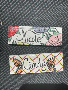 two pieces of fabric with the words, nicole and candy written on them are sitting next to each other