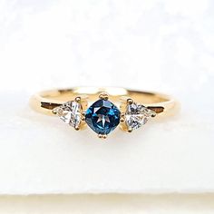 three stone ring with blue and white diamonds