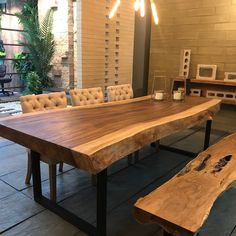 a large wooden table sitting next to a bench