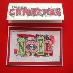 a christmas card with the word noel written in red and green on it next to an envelope