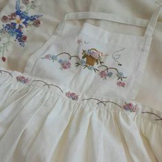 an embroidered dress with flowers on it