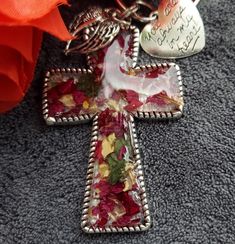 Custom made silver Cross made from your dried flowers from funeral, wedding or any meaningful occasion, Cross measures 2.34 inch by 1.58 inch with two side charms.  Cross can be used as pendant, keychain or Christmas ornament.  Pendant style comes with a 18 inch black cord with a 2 inch extender. Item details, Each item is individually made, resin is poured a mold then I carefully place your dried flowers and resin is again poured over both. Items are all handmade so no two items are the same, the item pictured is a example of your item will look like.  Upon purchase you will receive a email with instructions on how to dry your flowers and where to send them .  Note any left over flowers will be returned to you along with your order. I will start your order just as soon as I receive your d Silver Keychain With Lobster Clasp As Gift, Silver Keychain With Lobster Clasp For Gift, Personalized Silver Keychain Gift, Handmade Silver Keychain As Gift, Handmade Silver Keychain For Gift, Handmade Silver Keychains For Gifts, Custom Cross, Silver Cross, Dried Flowers