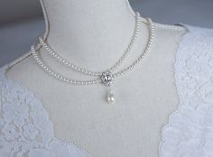 Vintage, Romantic Style White CZ  Necklace, Victorian Wedding Pearl and White CZ Bridal Choker,  Romantic Multi Row Vintage Swarovski Pearl  Materials used: - White/Ivory Cream Swarovski pearls - cubic zirconia stones - rhodium plated over brass The necklace will arrive packaged ready for gift giving in a delicate white jewelry box with a silver ribbon. Matching earrings for this necklace:  Back to my shop http://www.etsy.com/shop/crinadesign73 Thank you for visiting my store! Classic Pearl White Bridal Necklace For Wedding, Sewing Wedding Dress, Victorian Necklace, Bridal Pearl Necklace, Bridal Choker, Pearl Bridal Jewelry, White Jewelry Box, Victorian Wedding, Cz Necklace