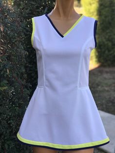 Here is a vintage 1970s polyester white tennis dress.Made by Fun Fads of Palm Springs.Following are the measurements, Bust 32",waist 28", Hips 40",Length measured from top of shoulder to hem 28".Zips up the back. Navy Blue and yellow V neck trim.Hem also has the same trim.Same trim on the neck.In nice vintage condition.If you live overseas please email me before purchasing for mailing cost. Price quoted is for USA only. Please take special note of measurements. 1970s sizing was much smaller than White Stretch Lined Dress, Fitted White Tennis Dress, Casual White Tennis Dress, Blue Tennis Dress For Spring, White Fitted Casual Tennis Dress, Blue Spring Tennis Dress, Spring Blue Tennis Dress, Fitted V-neck Tennis Dress, Blue Sleeveless Spring Tennis Dress