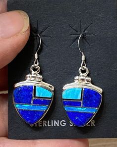 "This beautifully well crafted Triangle Berry shape Dangle earrings are handmade by a Navajo Artisan. The Colors of the Earrings come from Lapis Lazuli, Turquoise and Blue Opal. They are stamped Sterling and signed by the Artist. The Earrings measure 1 3/8\" long and a bit over 1/2\" wide. There are two different pairs available and they will vary in color. \"Winds of Wisdom\" (Lapis Lazuli, Turquoise and Blue Opal. The Navajo (Dine') believe that the wind is a powerful source. The native tradit Southwestern Style Blue Pierced Earrings, Southwestern Blue Earrings For Pierced Ears, Southwestern Style Blue Earrings For Pierced Ears, Artisan Blue Earrings, Artisan Blue Drop Earrings, Artisan Blue Nickel-free Earrings, Nickel-free Blue Southwestern Earrings, Southwestern Blue Drop Earrings, Southwestern Style Blue Drop Earrings