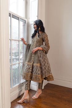 Please note the following before purchasing: 3 piece suit comes with matching pants and dupatta. Shirt length: 45 inches The shirt is organza with dori embroidery and sequins and features gold laces with stones. The dupatta is also organza with gold embroidery and sequins. The pants are sage and gold jamawar. We do not offer returns or exchanges on this item. We cannot make any exceptions to this policy. Each item is handmade and requires exquisite craftsmanship, thus please allow 35-40 days for Gold Straight Kurta Set With Intricate Embroidery, Party Wear Wedding Kurta With Zari Work, Wedding Party Wear Kurta With Zari Work, Gold Jamawar Set With Intricate Embroidery, Party Wear Sets With Intricate Embroidery On Tissue Silk, Party Wear Sets With Intricate Embroidery In Raw Silk, Party Wear Sets With Resham Embroidery In Organza, Party Wear Sets With Intricate Embroidery For Designer Occasions, Party Wear Organza Sets With Resham Embroidery