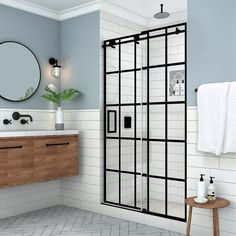 a bathroom with a sink, mirror and shower stall in the middle of the room