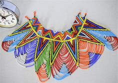 Unique African Maasai Handcrafted Beaded Necklace with an Elegant Look and Brilliant Finish.Color - Multi Color.Size - 13-13.5 inches.Fringe Length - 7 Inches / 18 cm.**GET FREE SHIPPING FOR ADDITIONAL ITEMS PURCHASED.Yes, Buy Multiple Items and pay shipping for 1 item only- The rest ships Free. (No Limits on the number of Multiple items). With a faster delivery time of 3 days via DHLExpress, Worldwide. Ordinary/Standard Shipping also available upon request. We Custom Make to Suit Your Taste and Multicolor Traditional Bib Necklace With Large Beads, Colorful Traditional Beaded Necklaces For Festivals, Traditional Multicolor Beaded Necklaces, Multicolor Artisan Beads For Festival, Bohemian Multicolor Bib Necklace With Large Beads, Multicolor Large Beads Bib Necklace For Festivals, Multicolor Beaded Chain Bib Necklace For Festival, Multicolor Bib Necklace With Dangling Beads For Festivals, Multicolor Bib Necklaces With Dangling Beads For Festivals