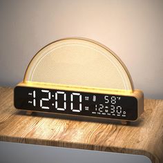 an alarm clock sitting on top of a wooden table