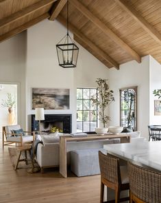 a living room filled with furniture and a fire place in the middle of a room