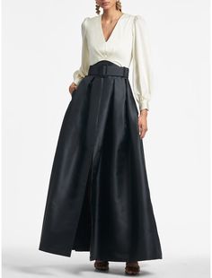 a woman is wearing a long black skirt