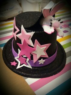 a black hat with stars and a rabbit on top