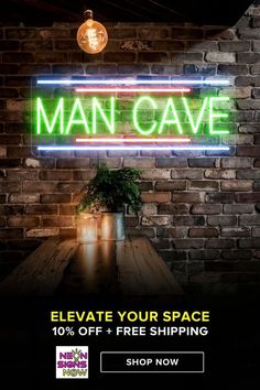 a neon sign that says man cave on the wall next to a table with a potted plant