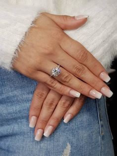 a woman's hands with french manies and a diamond ring on her finger