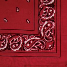 a red bandanna with white paisley on the border and a black square in the middle