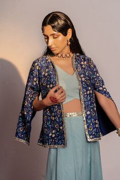 Featuring a royal blue jacket & palazzo set in viscose raw silk base with kasab, cutdana,flower sequin, mirror and moti hand embroidery. It is paired with a matching embroidered & printed viscose georgette kali palazzo & bustier. Spring Festive Bandhgala With Gota Work, Traditional Spring Bandhgala With Gota Work, Traditional Bandhgala With Gota Work For Spring, Blue Long Sleeve Palazzo Set With Floral Embroidery, Blue Bandhgala With Mirror Work For Festive Occasions, Blue Bollywood Bandhgala With Mirror Work, Blue Palazzo Set For Spring Party, Blue Long Sleeve Chanderi Bandhgala, Blue Raw Silk Palazzo Set With Mirror Work