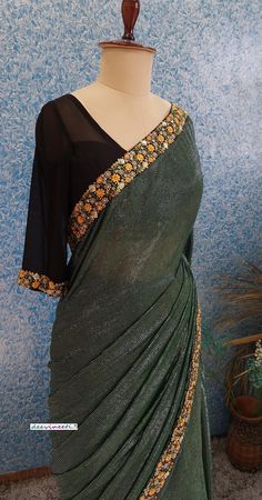 Color : Bottle Green with Shimmer Stripes Fabric - Polyester with multicolor embroidered border Blouse : Black Georgette Blouse (Made to Measure) Underskirt Included The blouse and petticoat will be stitched as per the measurements provided IF YOU WISH TO PURCHASE THIS WE CAN SEND A VIDEO ON YOUR WHATSAPP NUMBER FOR BETTER UNDERSTANDING OF THE SAREE PLEASE NOTE: BUYERS ARE RESPONSIBLE FOR ANY CUSTOMS AND IMPORT TAXES THAT MAY APPLY. Fabric Care : Dry Clean Only Disclaimer: The actual color of the product might slightly differ from the image due to photographic lighting or monitor's display Shipping: In case you are opting for stitched blouse and petticoat, once you place the order we will provide you with a template for measurements (to be taken in inches). It usually takes a week's time f Festive Green Pre-draped Saree With Embroidered Border, Designer Green Pre-draped Saree With Embroidered Border, Multicolor Embellished Georgette Saree, Embellished Multicolor Saree In Georgette, Festive Green Pre-draped Saree With Floral Embroidery, Green Designer Dress With Embroidered Border, Designer Green Embellished Saree, Green Semi-stitched Embellished Saree, Green Embroidered Saree With Mirror Work