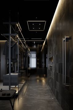 an empty hallway with black walls and lighting