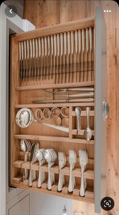 a wooden cabinet filled with lots of silverware