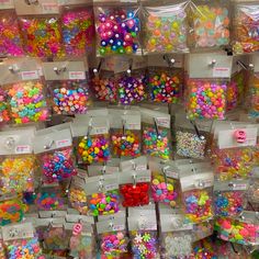 there are many bags with different types of buttons on them in the store, and one bag is filled with candy