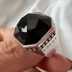 Stunning Statement Onyx Ring By Lagos I Purchased Over 10 Years Ago At Nordstrom & Wore It Few Times Only, Stored In The Safe For Years. Long Retired And This Exact Ring Is Not Available Anyplace. Hallmarked, Also Stamped 7 Insude Shank For A Size 7. All Pictures Are Part Of The Description. Substantial Piece Of Jewelry, Definitely A Statement Piece. Onyx Is Beautifully Faceted. The 18k Yellow Gold Small Accents Provide Richness To This Ring! Very Sleek Design, Perfect For Everyday Wear Despite Being A Very Large Ring, Wont Snag On Anything ! Also, A Unisex Ring And Will Look Equally Amazing On Mens Or Ladies Hand! Absolutely Stunning, Well Made Ring! Designer Black Jewelry For Formal Occasion, Designer Black Jewelry With Polished Finish, Designer Black Round Jewelry, Designer Black Ring With Black Enamel, Designer Black Enamel Ring, Luxury Black Rings With Vs Clarity, Designer Black Jewelry With Black Enamel, Designer Black Enamel Jewelry, Designer Black Rings For Anniversary