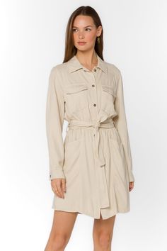 Add some sophistication to your wardrobe with the Deena Dress. This soft mini shirtdress features a stylish collar and snap button closure. With long sleeves and functional pockets, it's both practical and trendy. Complete the look with the self-belt for a flattering fit. Material: 60% Tencel™ and 40% Linen Machine wash cold or dry clean Color: Wheat Model is 5'9" and wearing a size S Imported Wheat Dress, The White Album, New Tops, Shirtdress, Cami Tanks, Jacket Sale, Sweater Jacket, Snap Button, Jacket Outfits