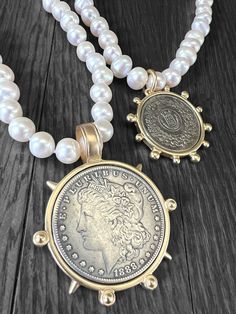 This stunning necklace design features hand knotted white freshwater pearls and your choice of reproduction coin pendant (50mm Morgan Peace Dollar Coin, 40mm French Coin, or 40mm Queen Elizabeth); Pearl necklace is 18 inches in length and pearls are approximately 9-10 mm in size.  Pearls are authentic freshwater potato pearls. Clasp is gold (brass). I also carry freshwater pearl stud earrings which can be found here: https://www.etsy.com/listing/1324859137/luxe-pearl-studs-freshwater-pearl-studs?click_key=d07efc4535abf278793858c89410802cceb6220e%3A1324859137&click_sum=6c40c58e&ref=shop_home_active_1&pro=1