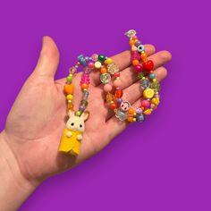 Bring some whimsy to your outfit with our Critter Bead Necklace, adorned with a charming Calico Critter. Each necklace is one-of-a-kind, handmade in Manchester, UK with varying colors and beads for a unique touch. Elastic thread and a clasp closure make it easy to wear. Calico Critter, Elastic Thread, Beaded Necklaces, Bead Necklace, Manchester, Porter, Etsy Accessories, Beaded Necklace, Fashion Inspo