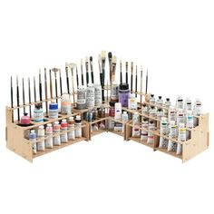 a wooden display case filled with lots of paint and brushes on top of each other