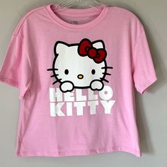 Adorable Medium Pink Color Cropped Hello Kitty Tee Shirt Is Lightweight Made From A Cotton Polyester Blend. New With Tags. Size Medium. Measurements Laying Flat Are Approximate (See Photos): Armpit To Armpit - 17” Length- 20” Cropped Length Hello Kitty Fun Crew Neck Top, Hello Kitty Crew Neck Fun Tops, Trendy Pink Hello Kitty T-shirt, Hello Kitty Short Sleeve Top, Y2k Hello Kitty Print Short Sleeve Tops, Y2k Cotton Cat Print Tops, Hello Kitty Print Y2k Crew Neck Top, Pink Cotton Hello Kitty T-shirt, Fun Hello Kitty Short Sleeve Tops