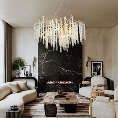 a living room filled with furniture and a chandelier hanging over the fire place