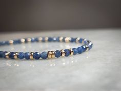 This gorgeous gemstone bracelet is made with high quality bright blue 3.3mm Sri Lankan Sapphire beads and is accented with 14k yellow gold filled Rondelle spacer beads scattered throughout. The gemstones are micro faceted and sparkle like glitter in the light. The micro faceting combined with the rich blue color or the beads makes them absolutely gorgeous in any light setting.  For the matching choker style necklace, please check my other listing: https://www.etsy.com/listing/1095955026/blue-sap Sapphire Beads, Luxury Blue Faceted Beads Bracelet, Choker Style Necklace, Blue Beaded Bracelets, Gold Bead Necklace, Diy Bracelets Easy, Gold Bead Bracelets, Crystal Beads Bracelet, Gemstone Beaded Bracelets