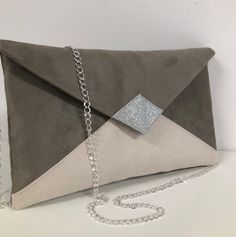 An elegant taupe-gray and ecru wedding clutch with silver sequins, this small envelope-shaped handbag, with or without removable chain, will be very fashionable for your outings, bridesmaids or a ceremony.  The evening clutch will easily hold your essentials: phone, make-up, keys, glasses, papers.... This clutch is made in taupe-gray and ecru suedette, with a velvety, suede-effect feel. The tip of the flap is covered with silver glitter fabric. 2 possible options WITH or WITHOUT chain strap, the Wedding Clutch Bag, Clutch Bag Wedding, Small Envelopes, Tablet Bag, Taupe Grey, Wedding Clutch, Glitter Fabric, Elegant Accessories, Chain Bag