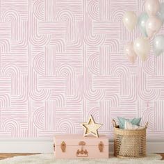 a room with pink and white wallpaper, balloons and a suitcase on the floor