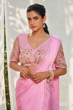 Pink pre-draped saree with an embroidered border. Paired with a padded sequin and pearl embroidered blouse. - Aza Fashions V-neck Blouse Piece For Diwali Reception, Unstitched Georgette Blouse For Eid, Saree With Unstitched Blouse For Reception, Semi-stitched Draped Blouse Piece For Eid, Unstitched Georgette Blouse For Reception, Georgette Blouse For Reception, Saree Blouse With Resham Embroidery For Reception, Chinon Saree Blouse For Eid, Festive Blouse With Dupatta In Chinon