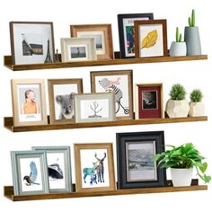 two wooden shelves with pictures and frames on them