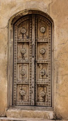 an old wooden door with intricate carvings on the front and side doors are open to let in light