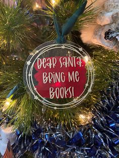 a christmas ornament that reads deep santa bring me books on the front of a tree