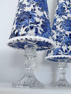 two blue and white vases sitting next to each other on top of a table