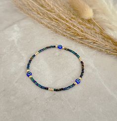 Evil Eye Bracelet - Evil Eye Jewelry - Blue Evil Eye Bracelet, Iridescent Blue Bracelet - Gold Filled Bracelet - Dainty Gold Bracelet - Stretchy Evil Eye Bracelet  * D E T A I L S * This bracelet is made with: Miyuki Seed Beads 14K Gold-filled beads Stretch Cord * Q U E S T I O N S * If you have any questions, please send me a message 🖤 Bracelet Or, Tiny Bead Bracelet, Bracelet Evil Eye, Dainty Gold Bracelet, Iridescent Blue, Bracelet Dainty, Jewelry Blue, Blue Evil Eye, Eye Bracelet