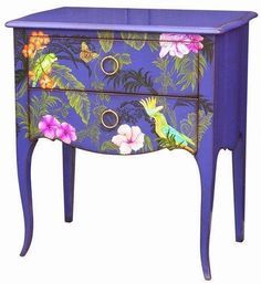 an ornate blue dresser with flowers and birds painted on it