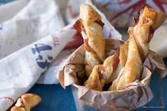 some bread sticks are in a cup on a table