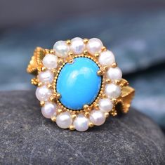 Oval Turquoise And Pearl Engagement Ring Rose Gold Turquoise Ring Sterling Silver Turquoise Ring Vintage Ring Birthstone Ring Promise Ring. 10K/14K/18K Rose, Yellow And White Gold. Main Stone: Turquoise  Main Stone Color: Blue Main Stone Shape: Oval Birthstone Month: December Secondary Stone : Pearl *Secondary Stone Type: Pearl  *Stone Size: 2mm *Stone Color: White *Stone Shape: Round Jewelry Type: Ring Metal: Silver Method: Cast Personalization: Possible Style: Wedding Ring Set Ring Size: We make rings from US 3 to US 10 *Secondary Stone Type: Pearl & Emerald *Stone Size: 2mm *Stone Color: White *Stone Shape: Round * Handmade * Center Stone Turquoise  * Brand New * All Ring Sizes Available * Suitable For Every Day * 14k Solid Gold / 18k Solid Gold / Gold Filled Over Sterling Silver * Puri Gift Turquoise Cluster Ring With Gemstone, Elegant Turquoise Ring With Natural Stones For Anniversary, Fine Jewelry Turquoise Cabochon Ring For Anniversary, Fine Jewelry Turquoise Wedding Ring, Fine Jewelry Turquoise Multi-stone Ring Gift, Turquoise Oval Cabochon Wedding Jewelry, Fine Jewelry Turquoise Cabochon Ring Gift, Ring For Wife, Turquoise Gold Ring